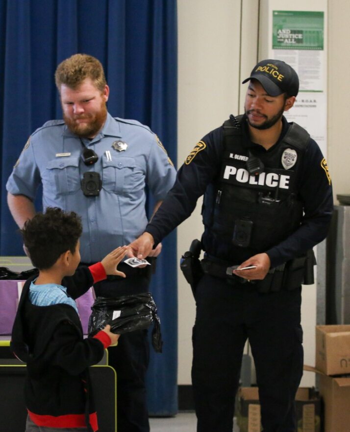 A boy gets a sticker from Tucson Police officers.