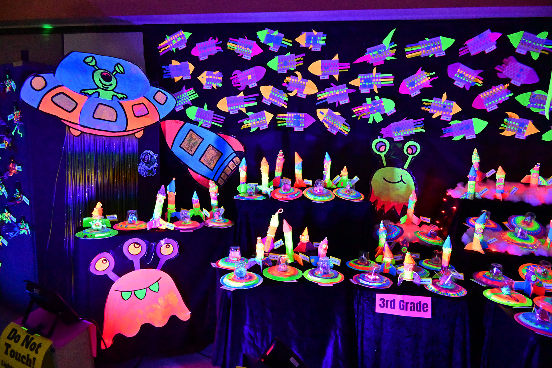 Glow art depicting rockets and aliens