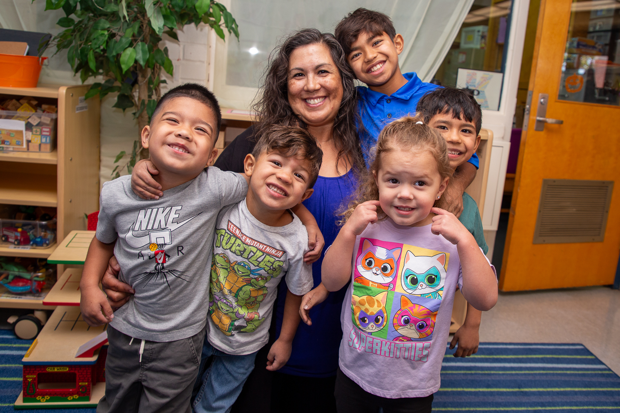 Principal Rachel Romero smiles with her 5 grandchildren who attend Erickson