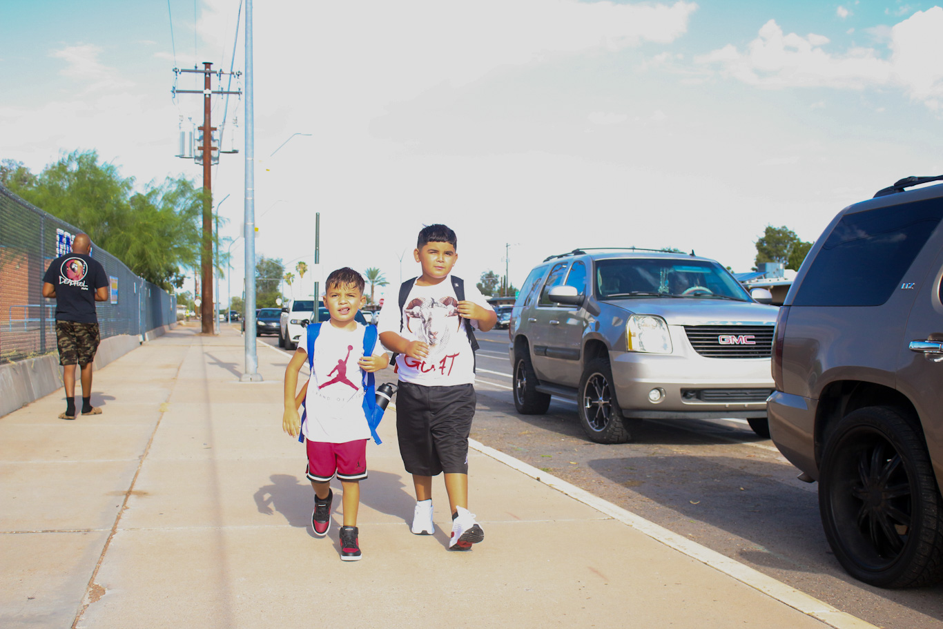 Two little boys walk together to school